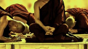 Buddhist monastics bowing to a senior monastic.