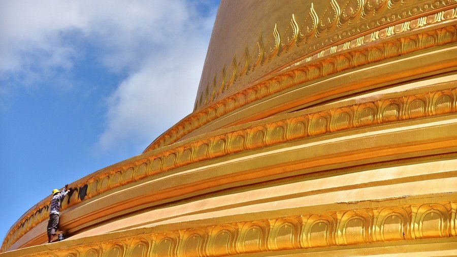 Very small person on a very large stupa.