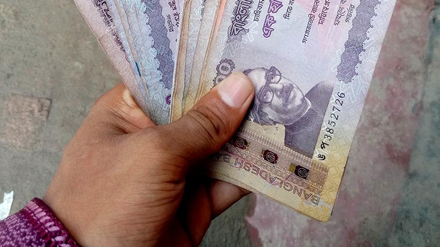 Hand holding currency.